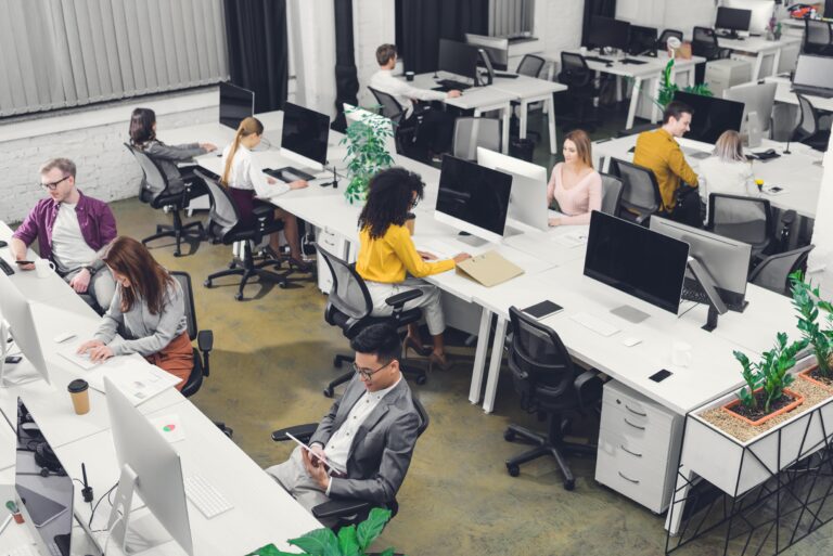 Busy office, people working at desktop computers