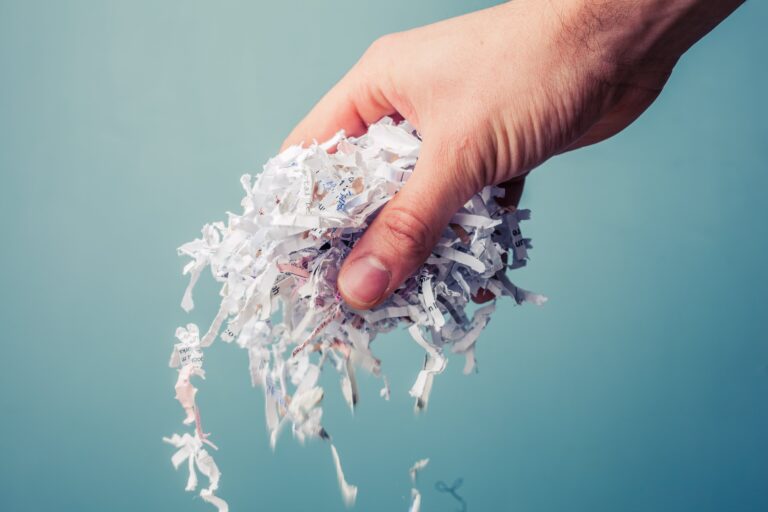 Hand holding a bunch of shredded paper