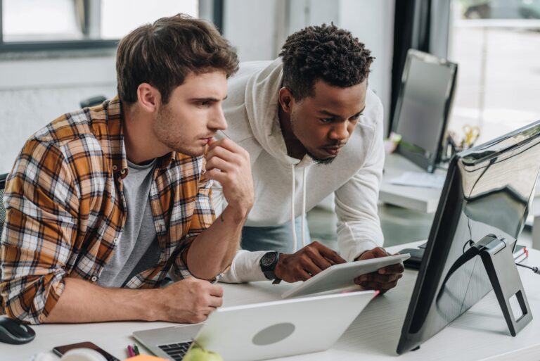 Two young men working on computers