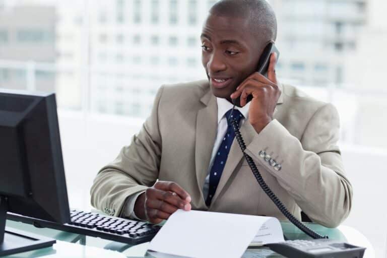 Man in suit talking on phone at work